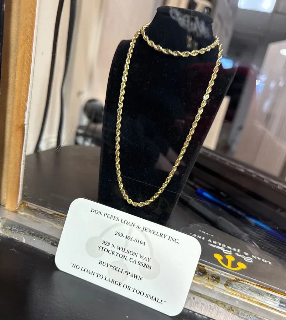 Gold rope chain and bracelet in the display case at Don Pepes Loan & Jewelry, gold and silver bought in Stockton