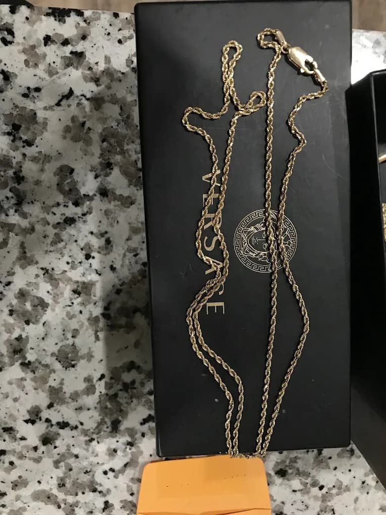 A gold rope chain displayed on the counter